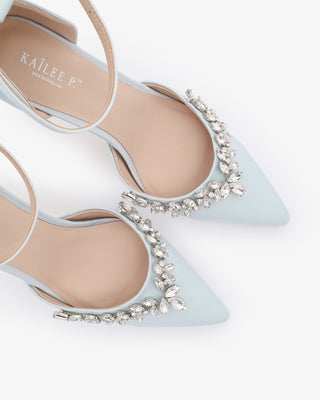 Light blue satin wedding heels with pointed closed toe and starlet rhinestone embellishment, perfect for bridal or formal occasions