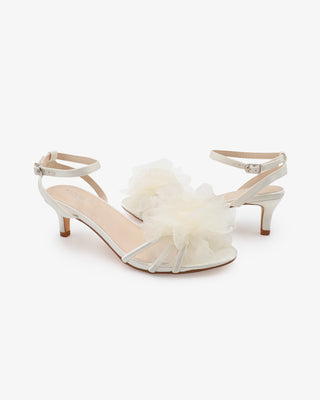 White satin strappy sandals with kitten heels and organza flower details 