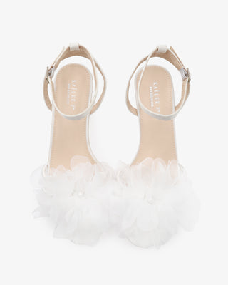 White satin strappy sandals with kitten heels and organza flower details 