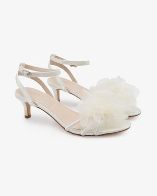 White satin strappy sandals with kitten heels and organza flower details 