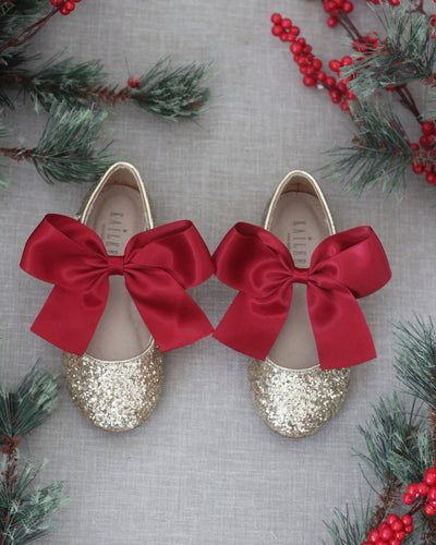 Gold glitter shoes with red bow